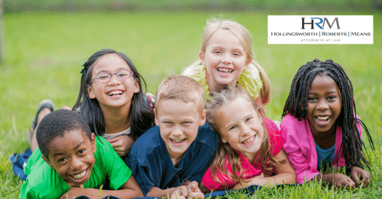 children laying on grass