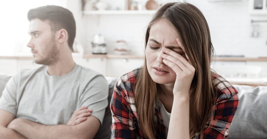 man and woman sitting unhappily