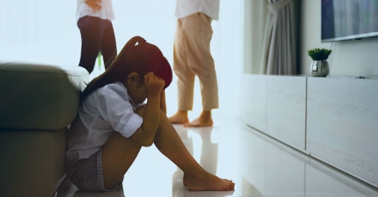 sad child with parents fighting