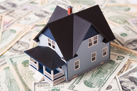 house model on top of dollar bills